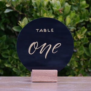 Hire Me: Acrylic Round Modern Black With Gold Lettering Table Number Sign + Stand - FoxAndHart
